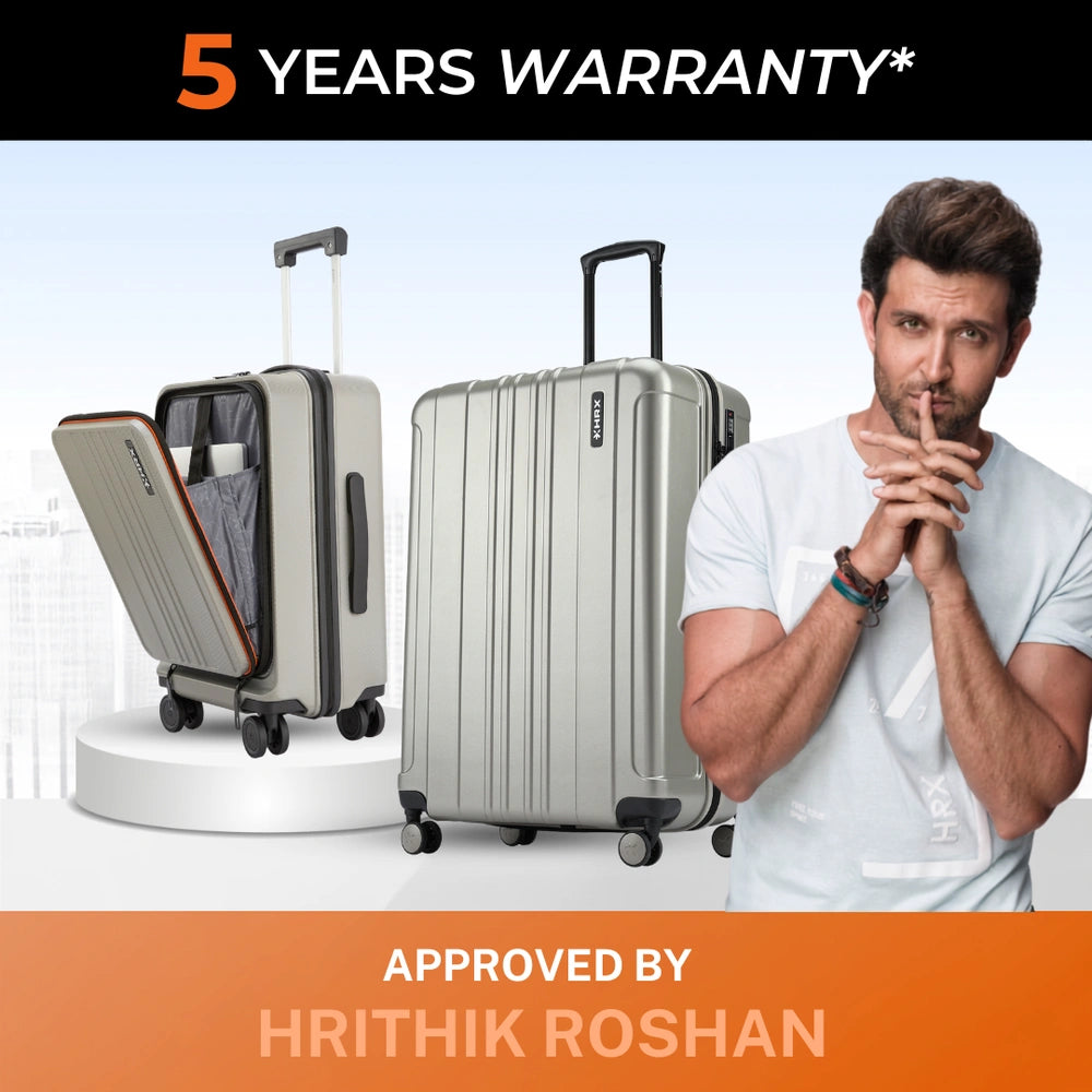 Silver hard-shell upright trolley suitcase with side handles and spinner wheels