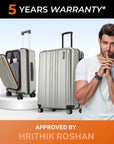Silver hard-shell upright trolley suitcase with side handles and spinner wheels