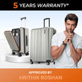 Silver hard-shell upright trolley suitcase with side handles and spinner wheels