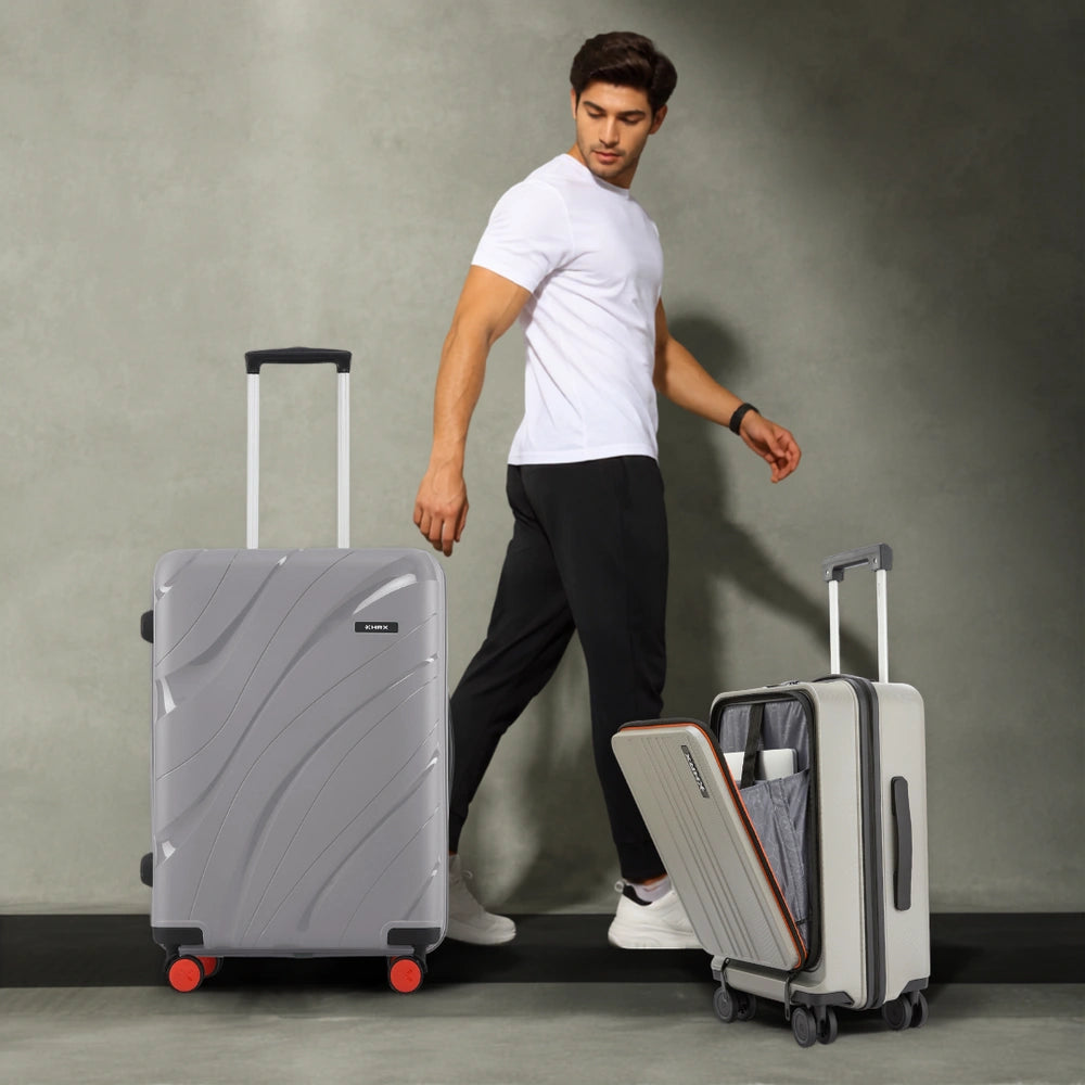 Medium grey hard-shell spinner suitcase with side handle and red wheel accents