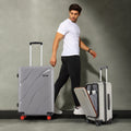 Medium grey hard-shell spinner suitcase with side handle and red wheel accents