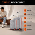 Grey hard-shell rolling suitcases with telescopic handles and red wheel accents