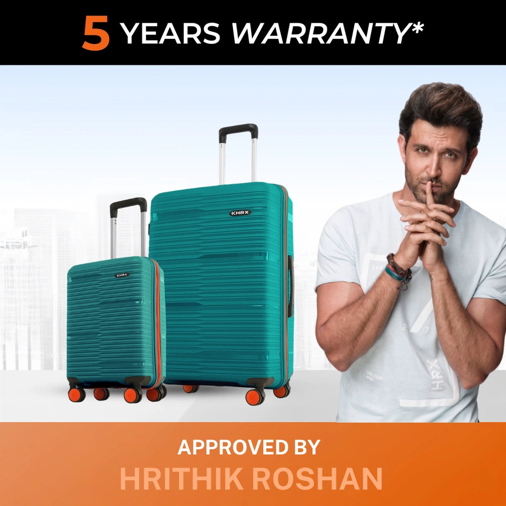 Teal hardshell cabin and large trolley suitcases with telescopic handles and spinner wheels.