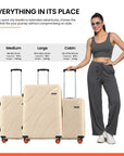 Set of beige suitcases in three sizes with telescopic handles and spinner wheels