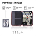 Open suitcase interior with compartments, straps, mesh pockets, and small accessories