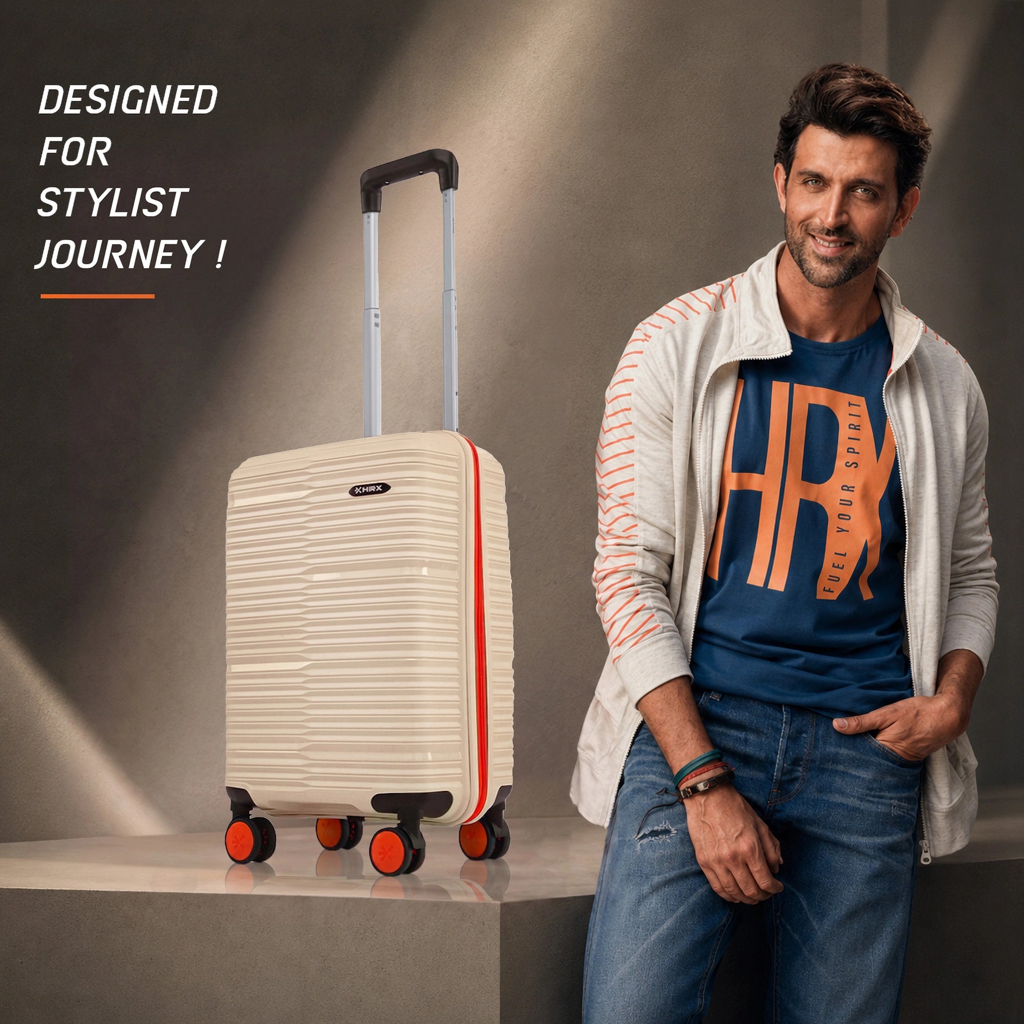 Beige small cabin suitcase upright with telescopic handle and orange spinner wheels
