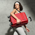 Red small cabin suitcase with black wheel set and extended side handle