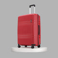 Hard-shell red luggage with telescopic handle, ridged front panel, and caster wheels.