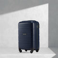Navy blue cabin trolley with hard shell, telescopic handle, and 4 wheels