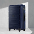 Dark blue polypropylene check-in trolley with 4 wheels, upright front view, side handle