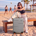 Light gray 75 cm spinner suitcase with telescopic handle, upright on 8 wheels