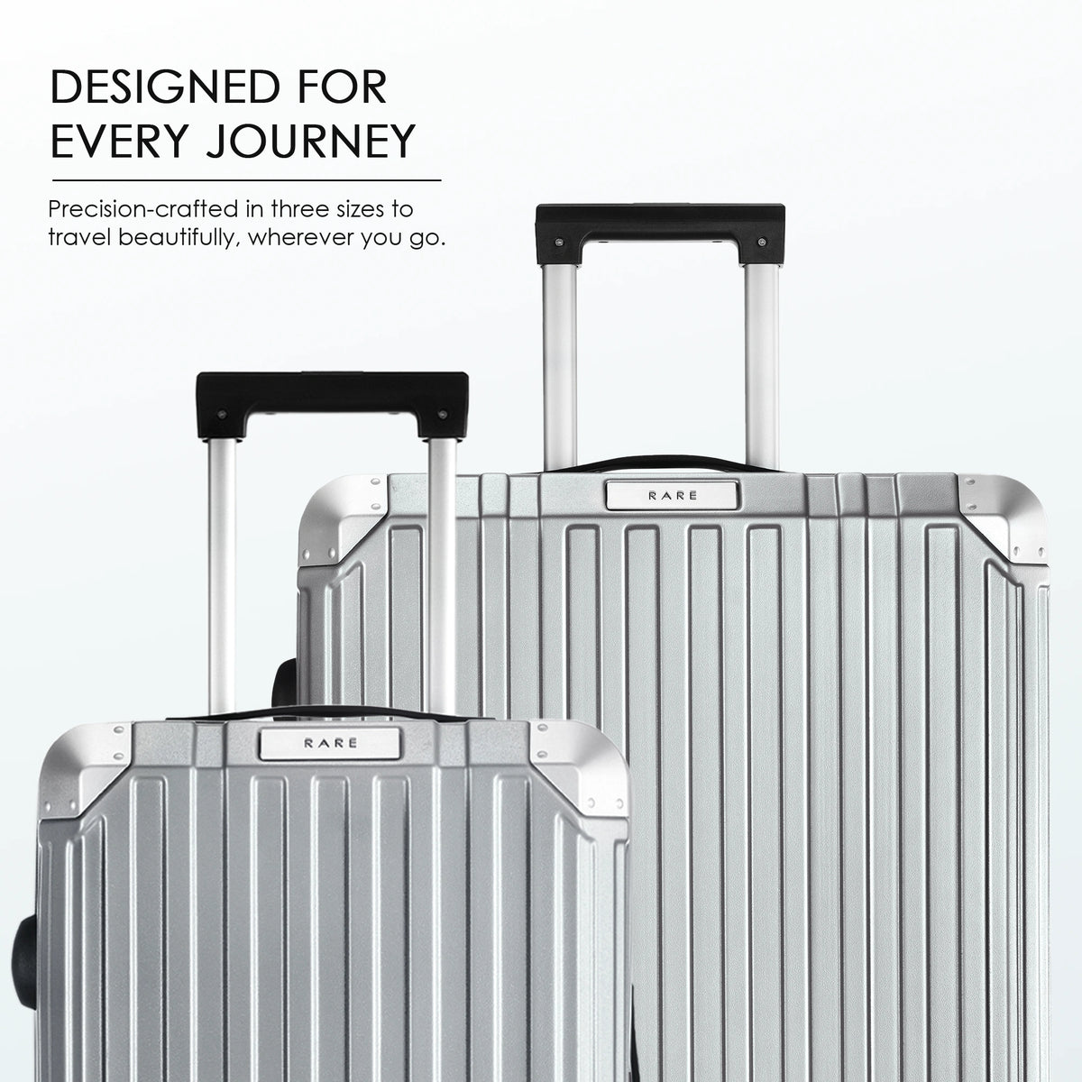 Stacked hard-shell suitcases with telescopic handles in silver