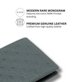 Dark olive leather bi-fold wallet with tonal monogram pattern and edge stitching
