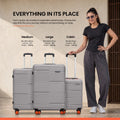 Set of hard-shell 8-wheel spinner luggage with extended handles, stacked side by side