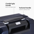 Dark blue hard-shell trolley suitcase with textured top carry handle