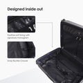 Dark blue hard-shell trolley suitcase interior with zip compartments and snap buckle
