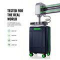 Dark cabin trolley suitcase with green wheel accents and upright handle, 8 spinner wheels.
