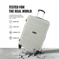 Light grey check-in trolley suitcase with reinforced shell, 4 wheels, and carry handle