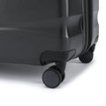 Large check-in suitcase corner with built-in wheels and shell texture, dark silver
