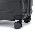 Small cabin suitcase with dark corner bumper and rolling wheel on the base