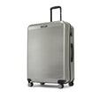 Silver hard-shell luggage suitcase side view with telescopic handle and built-in latch
