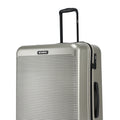 Silver hard-shell suitcase with side handle, zipper edge and HRX badge