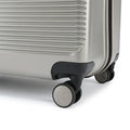 Silver hard-shell suitcase with corner bumper and dual spinner wheels