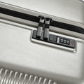 Silver hard-shell suitcase with combination lock panel and zipper