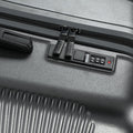 Charcoal grey rolling suitcase corner detail with zipper and carry handle latch