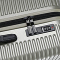 Silver 8-wheel carry-on suitcase showing zipper and built-in combination lock