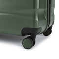 Large check-in suitcase corner with wheels and shell texture, green finish