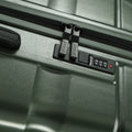 Green hard-shell suitcase front with zipper track and padlock-style latch