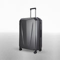 Hard-shell polycarbonate trolley suitcase, dark grey textured finish, side profile with spinner wheels