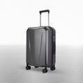 Hard-shell polycarbonate trolley suitcase, dark grey textured shell, top handle and spinner wheels