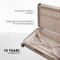 Beige hard-shell luggage open to show interior compartments and packing straps