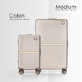Beige hard-shell polycarbonate trolley suitcase set with two-wheel rollers and gold stripe.