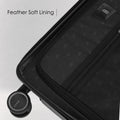 Black hard-shell polycarbonate suitcase interior lining with feather-soft trim and zipper pocket.