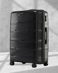 Large check-in trolley with 8 wheels, black hard-shell suitcase with vertical panel design