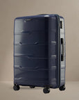 Large check-in trolley with 8 wheels, navy hard-shell suitcase with vertical panel design